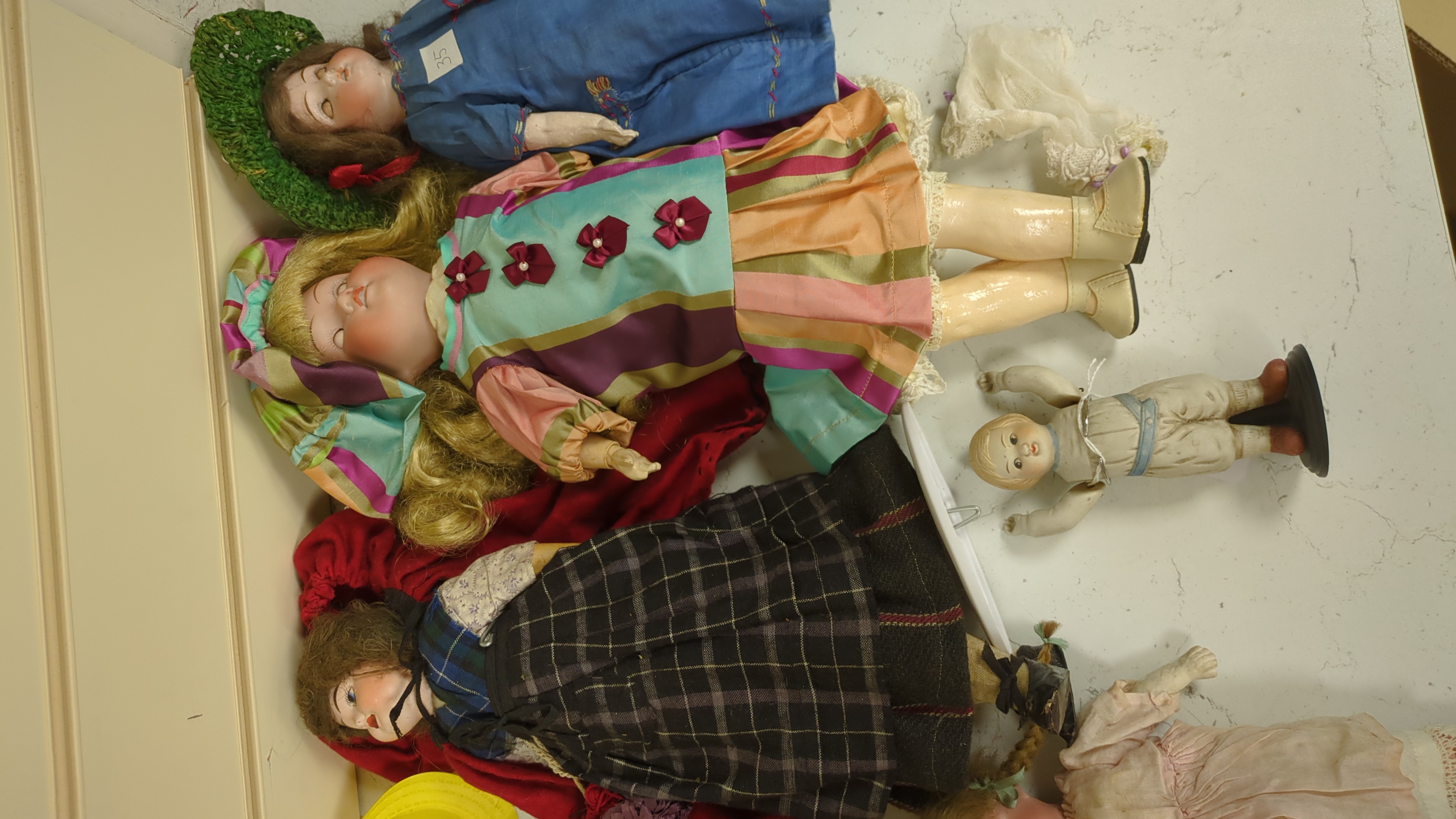 Nine assorted dolls including AMS and Kewpie